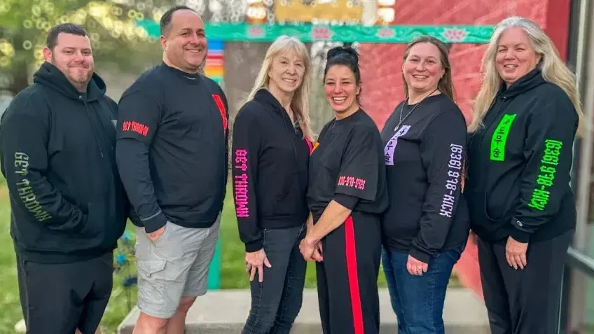 A group of people are posing for a picture together.