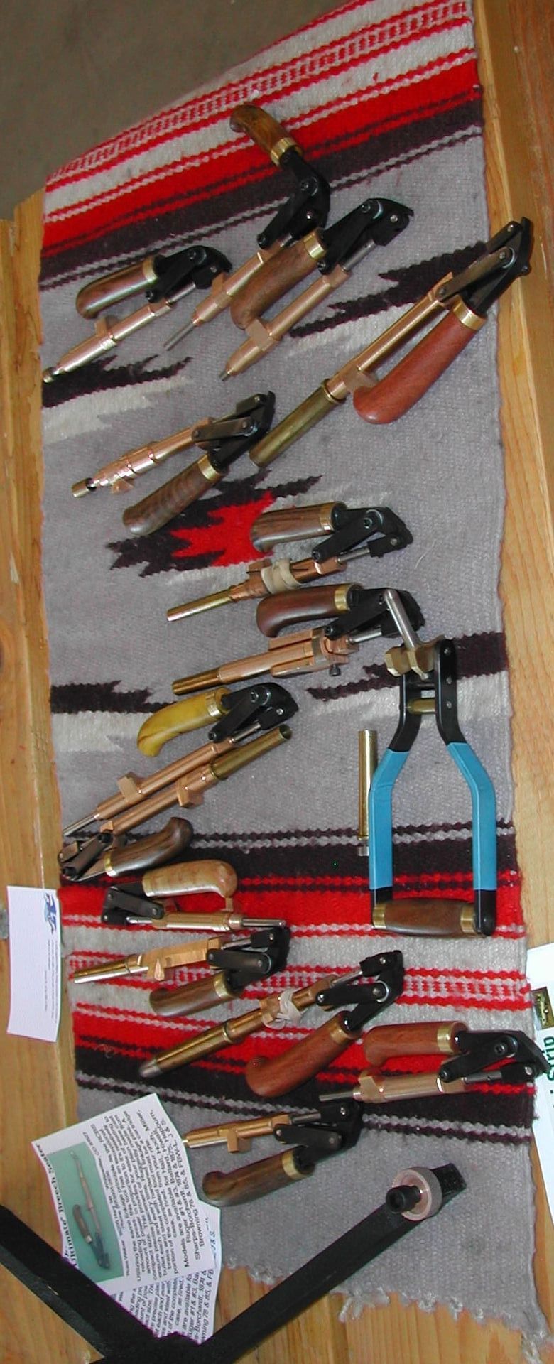 A bunch of knives are hanging on a wall