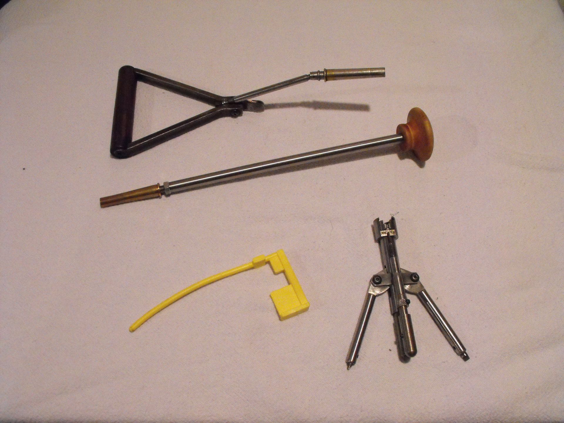 A bunch of tools are laying on a white cloth