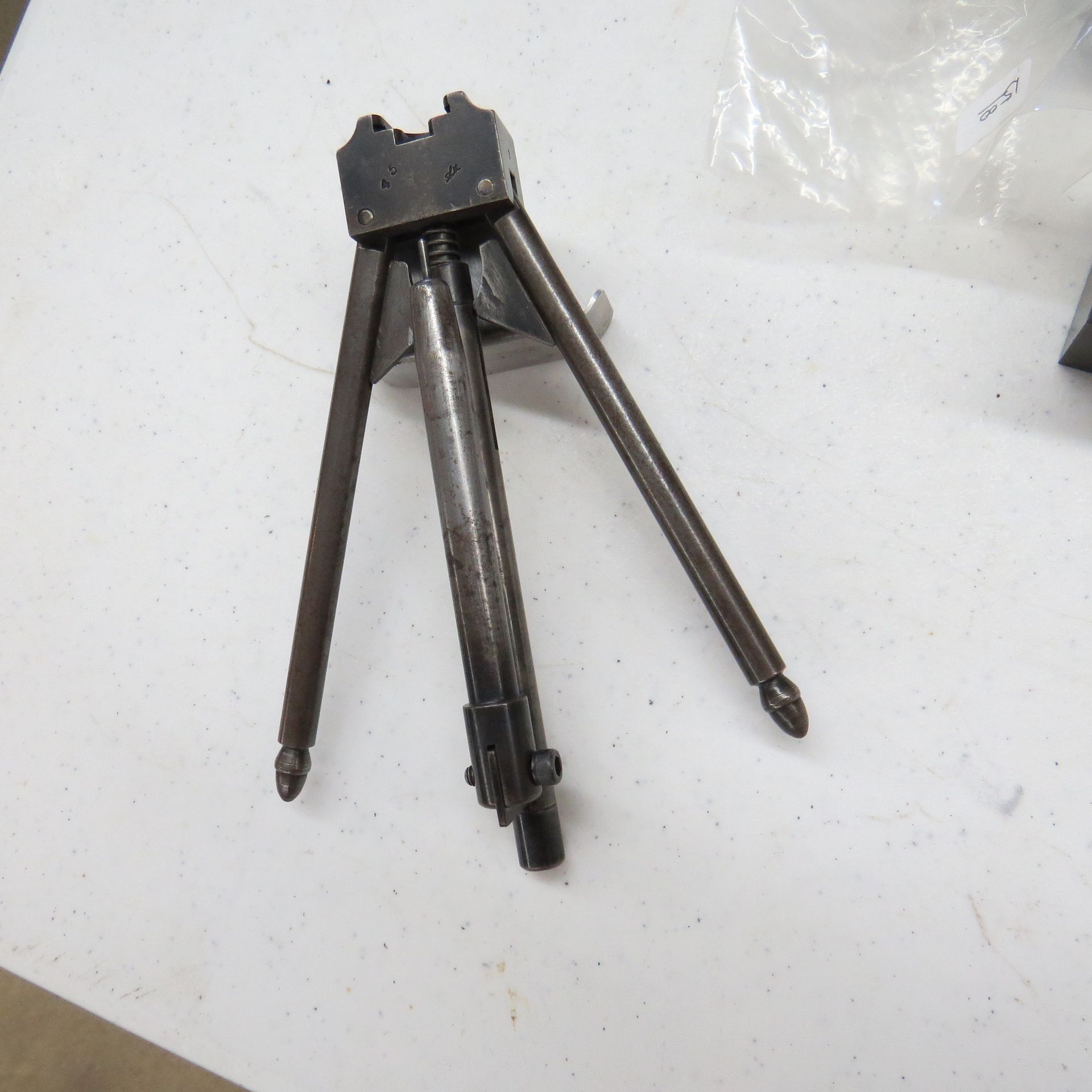 A tripod sitting on top of a white table