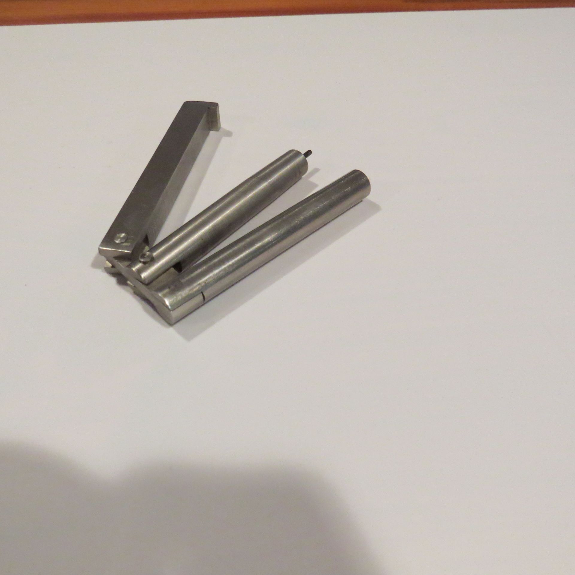 A pair of stainless steel pencils on a white surface