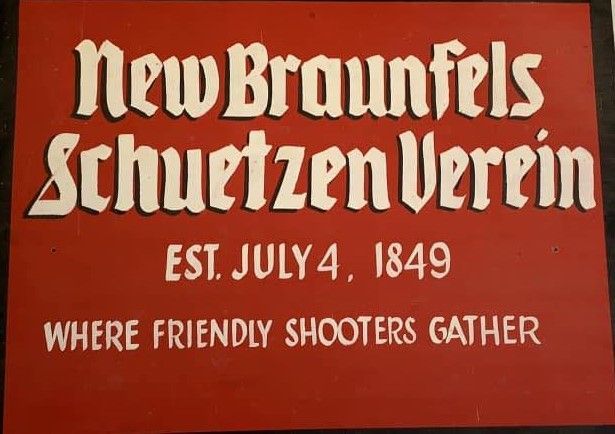 A red sign that says new braunfels schuetzen verein