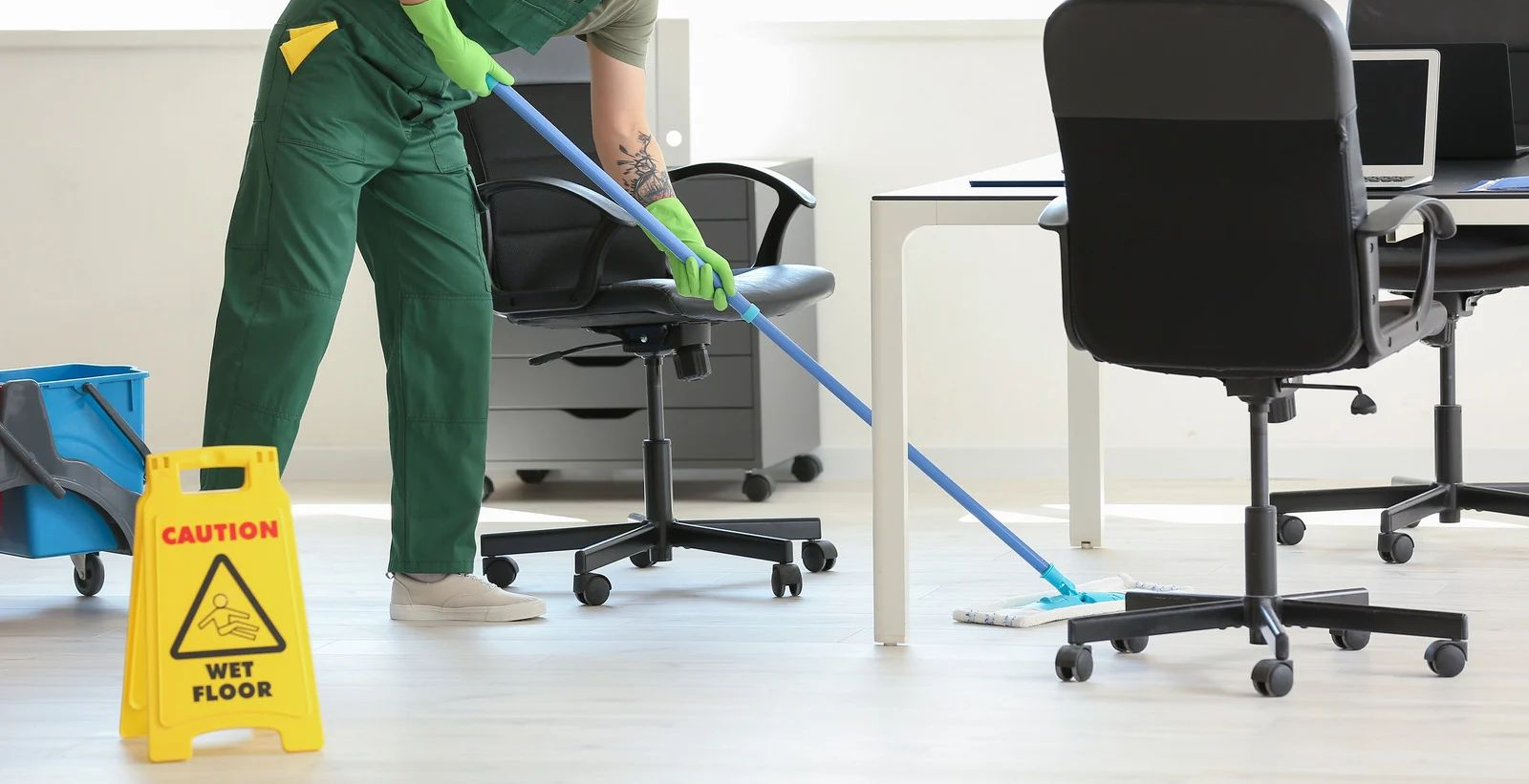 Person mopping an office floor. Yellow 
