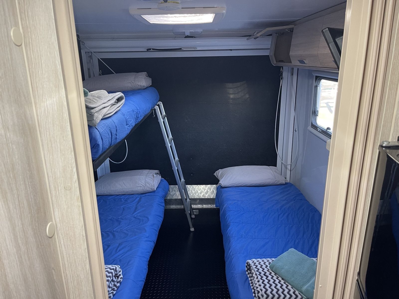 The Inside Of A Camper With Two Bunk Beds And A Ladder – Kempsey, NSW - Ezy Group Services