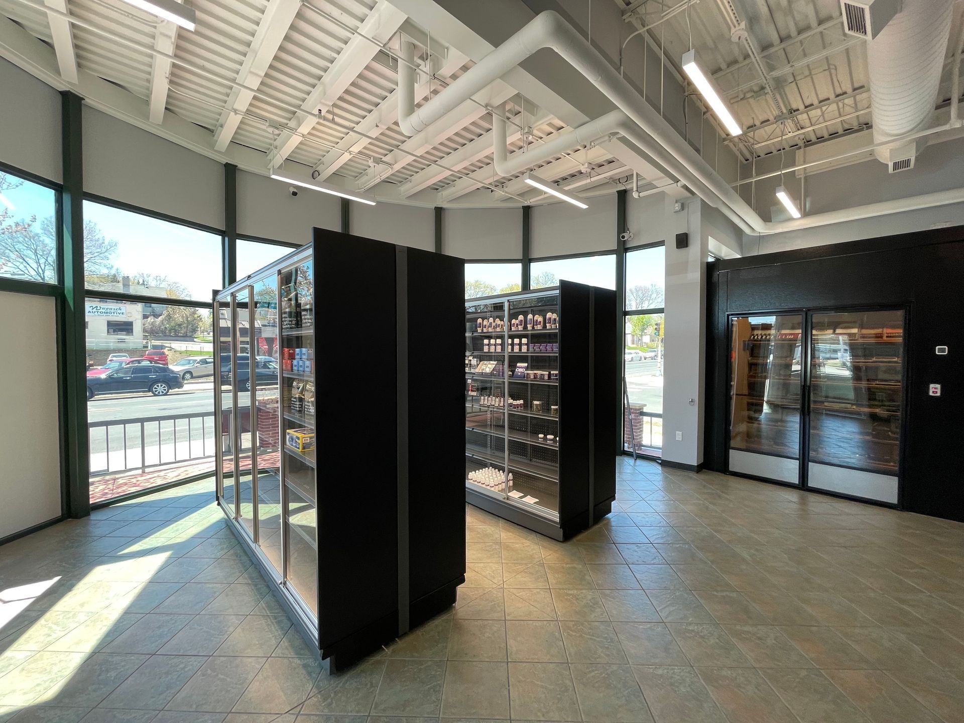 A large room with a lot of windows and shelves.