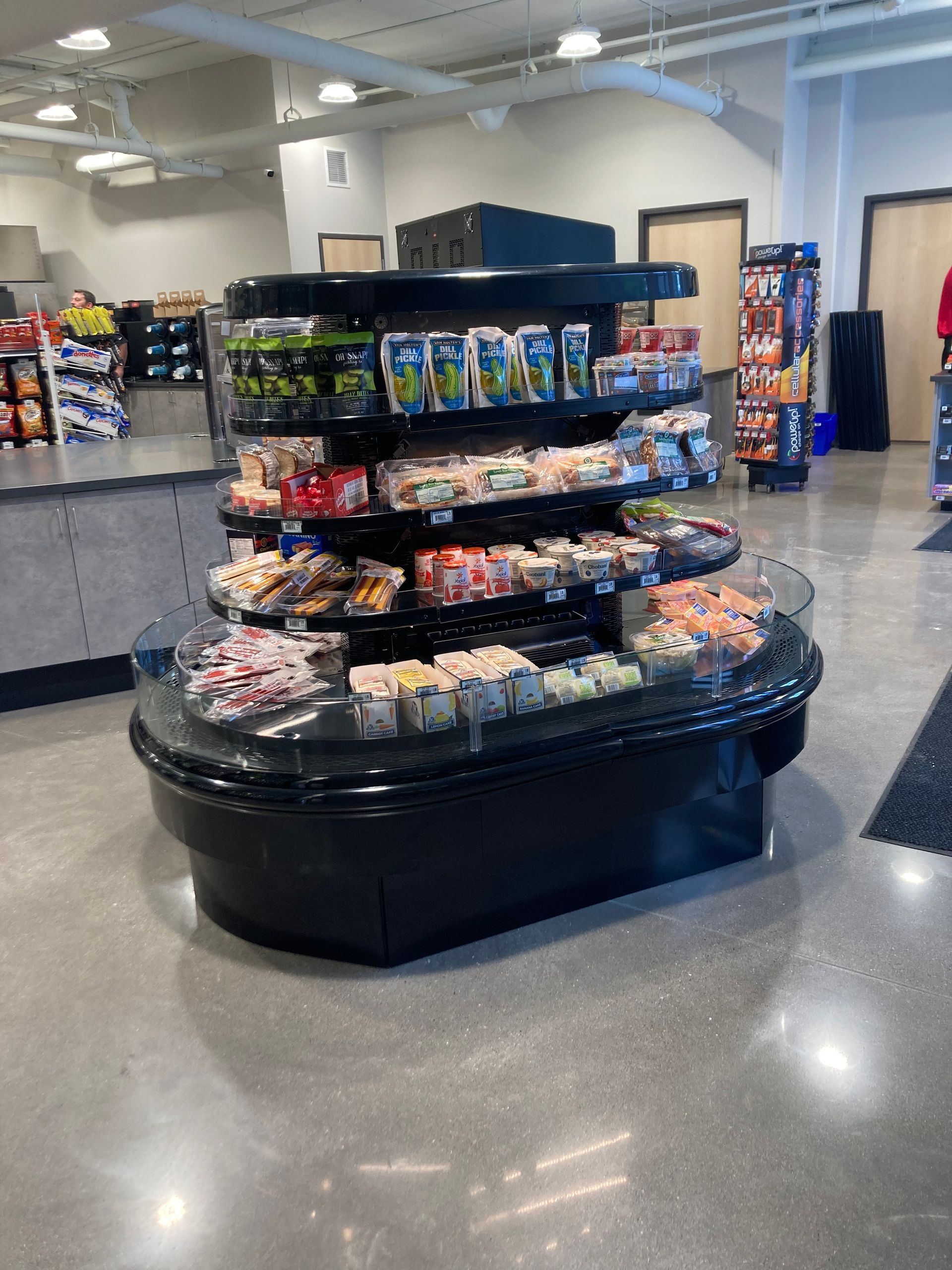 A display case in a store filled with lots of food.
