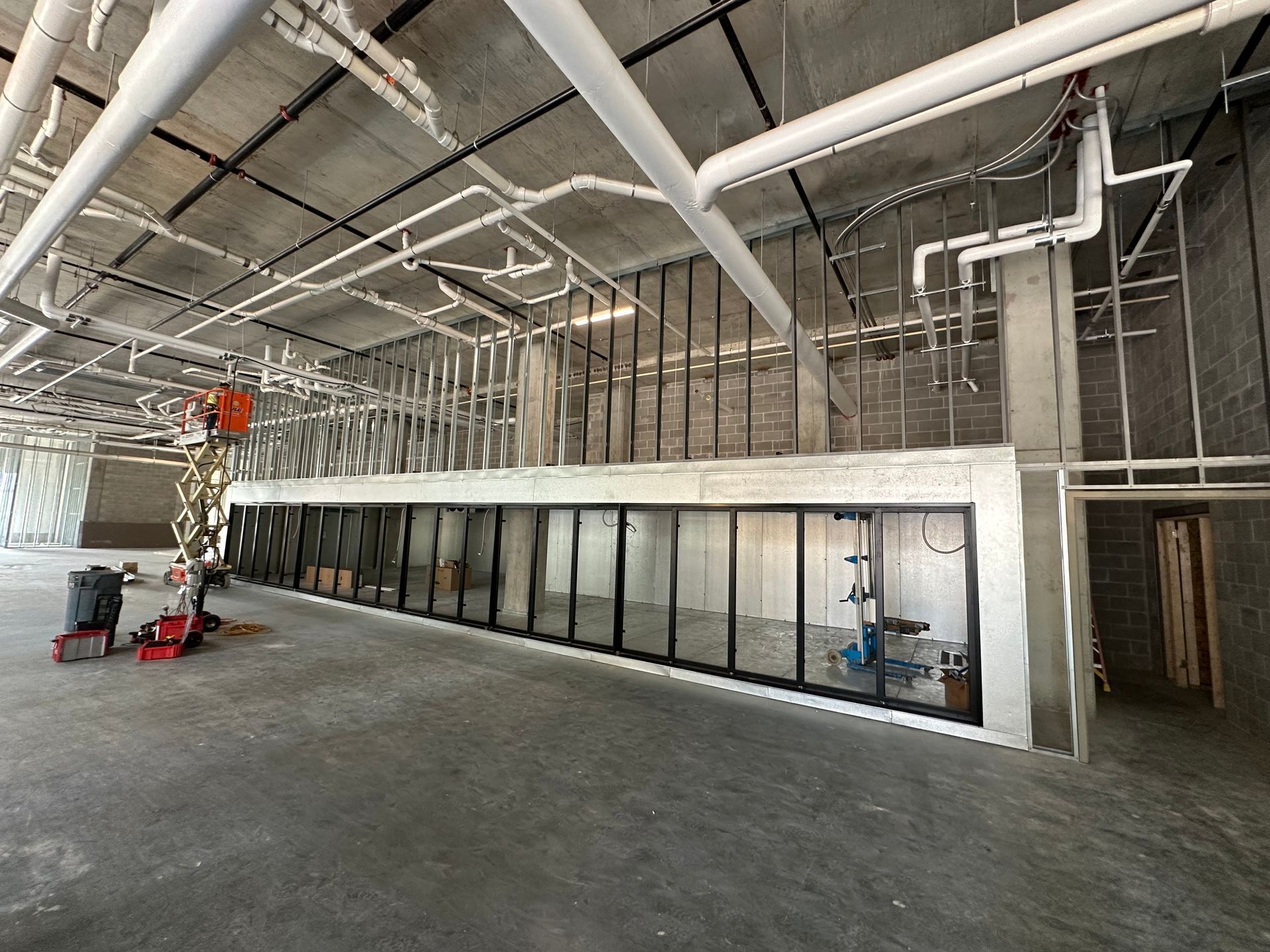 A large room with a lot of pipes hanging from the ceiling