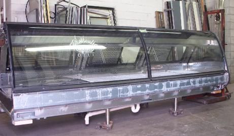 A large glass display case is sitting in a room.