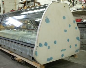 A large glass display case is sitting on a wooden pallet.