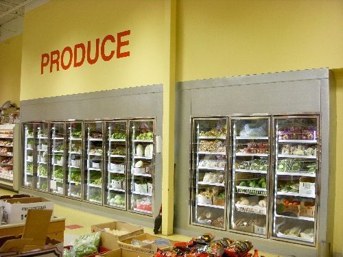 A produce section of a grocery store with lots of vegetables