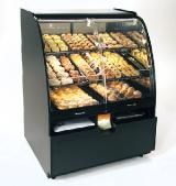 A bakery display case filled with lots of bread and pastries.