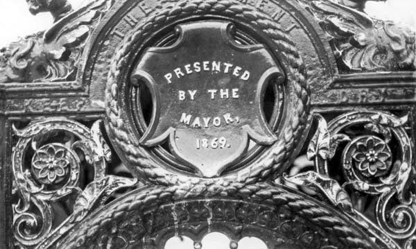 Close-up of ornate metalwork, reads