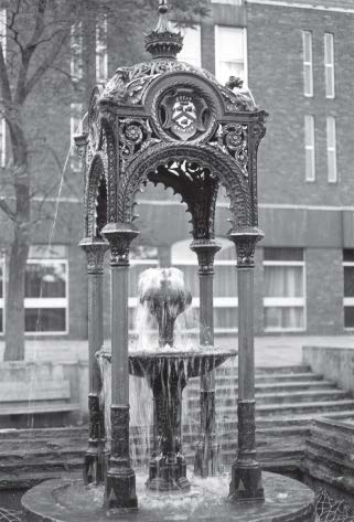Elaborate ornate fountain in a courtyard setting, water flowing.