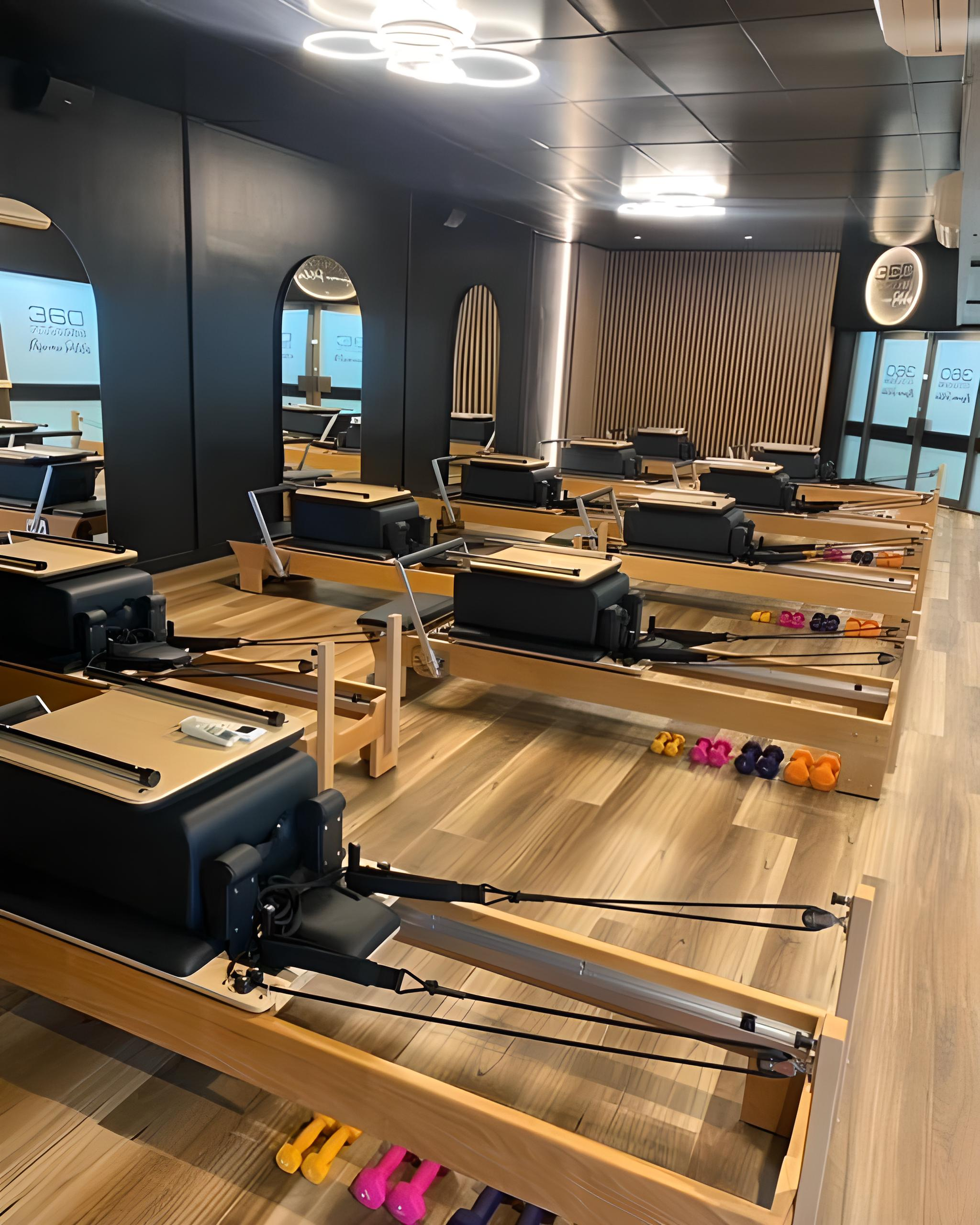 A row of pilates machines are lined up in a gym — 360 Fitness Group in Cairns, QLD