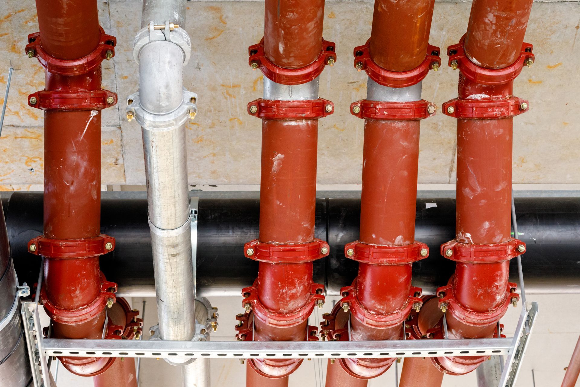 Person's hands inside a toilet tank adjusting the internal components. The tank is white, the surrounding walls are blue.
