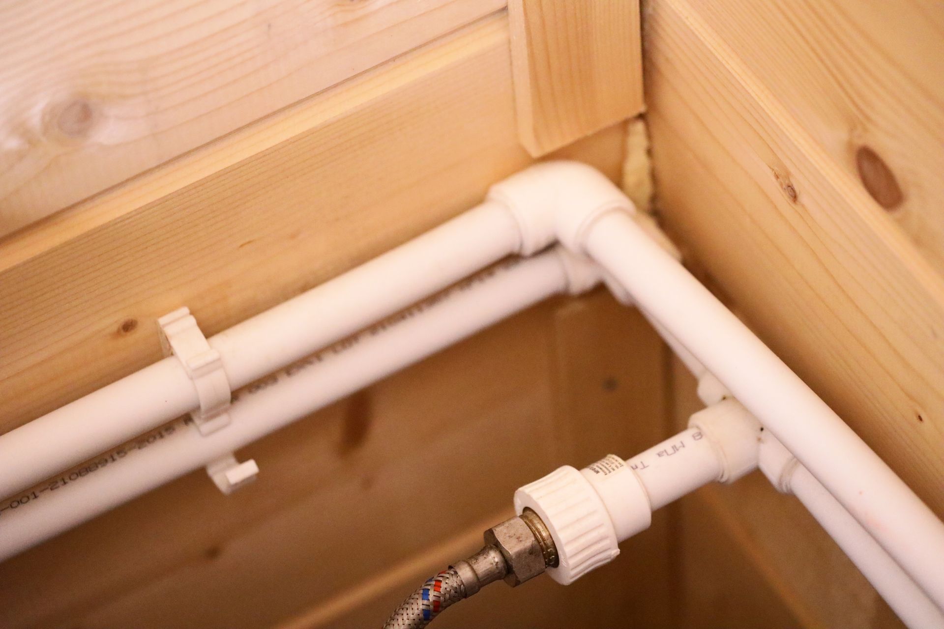A close up of a pipe in a wooden room.