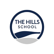 Logo for The Hills School, featuring a dark blue circle framing the text "THE HILLS SCHOOL" above a stylized dark blue hill outline and a gray base.