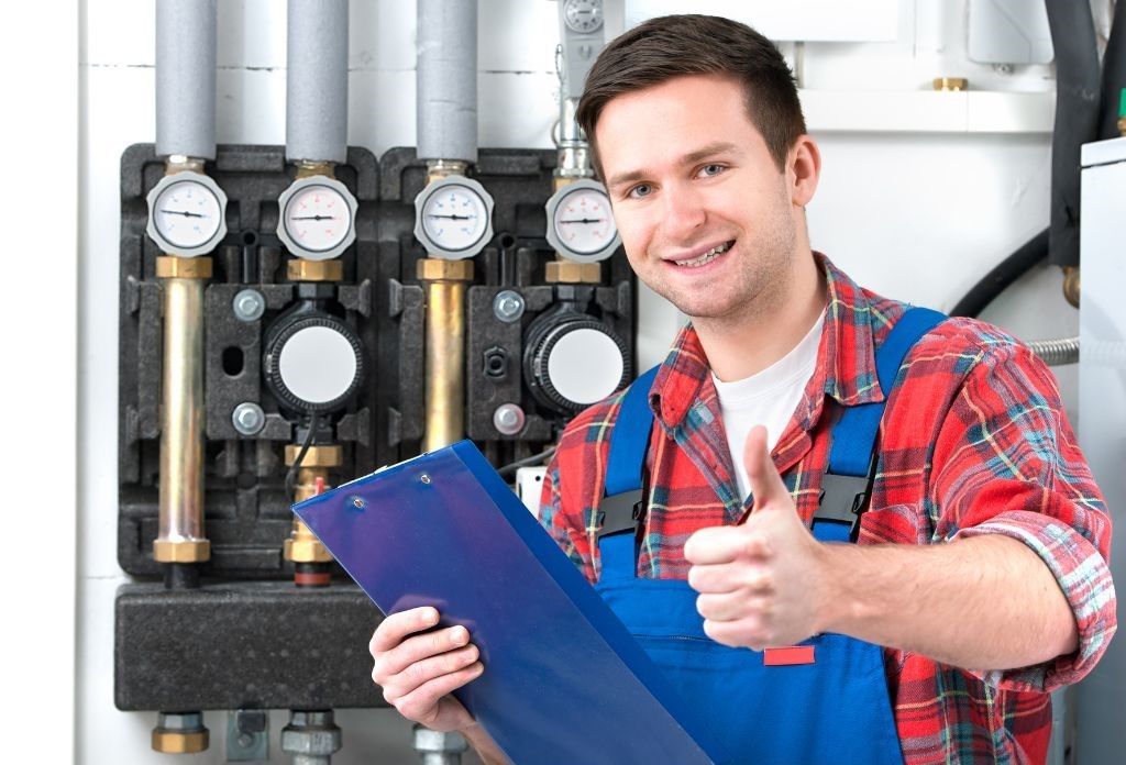 A man is holding a clipboard and giving a thumbs up.