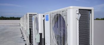 A water heater is next to an air conditioner in a room