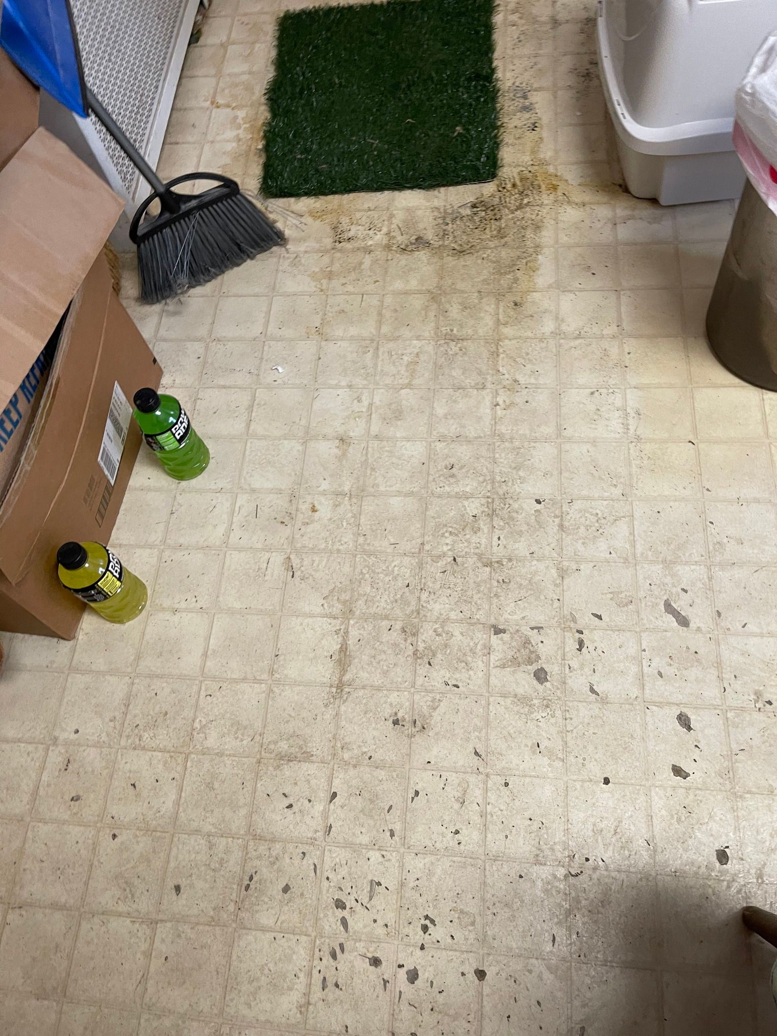 Before image of a dirty floor next to a boxes