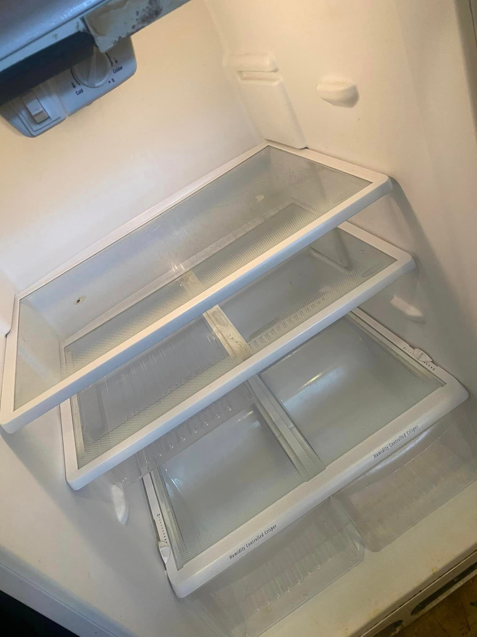 After is an image of the inside of an empty refrigerator with a lot of shelves that is so clean and glimmer