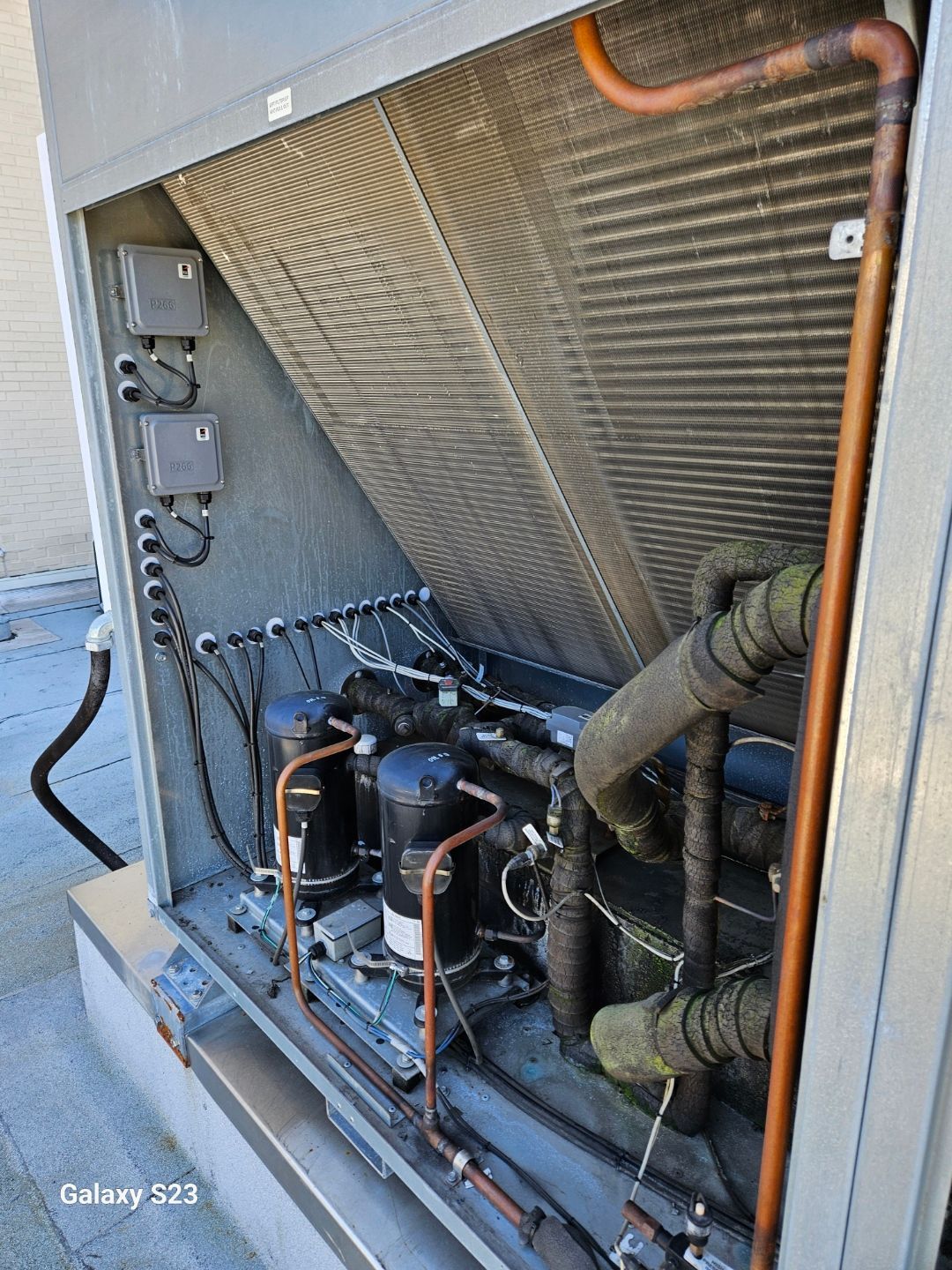 The inside of a building with a lot of pipes and wires