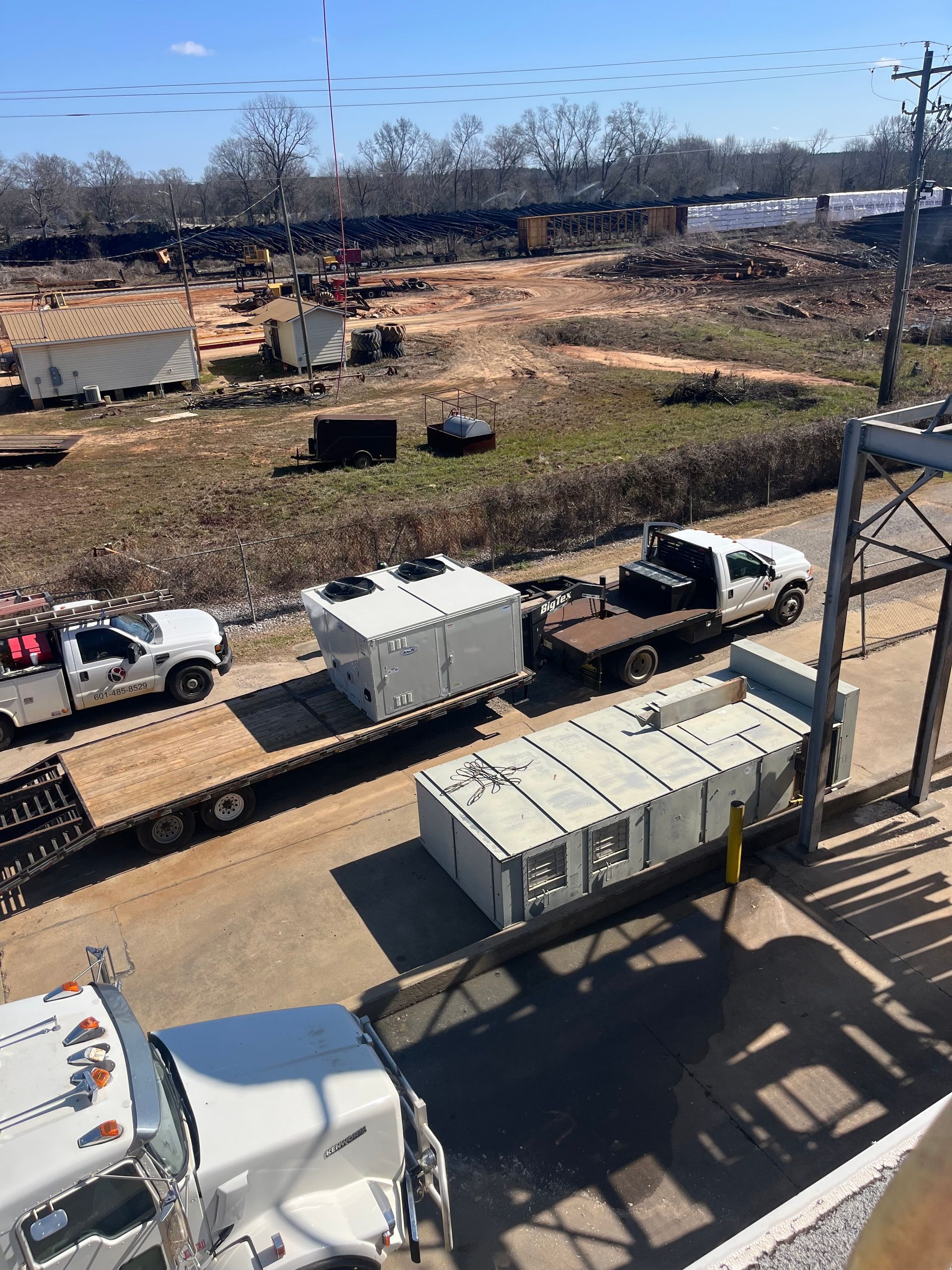 A bunch of trucks are parked on the side of the road.