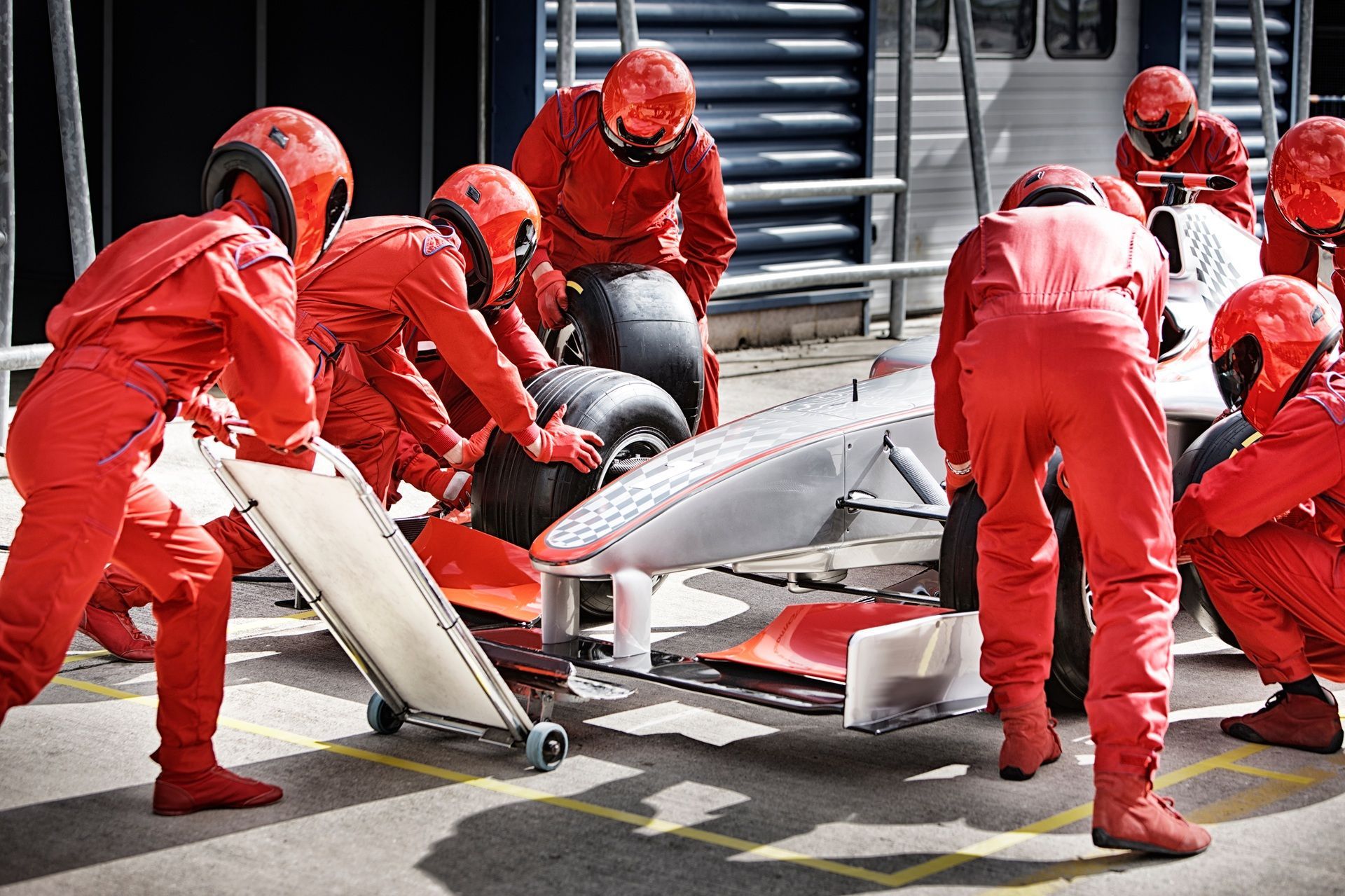 A group of men are working on a race car