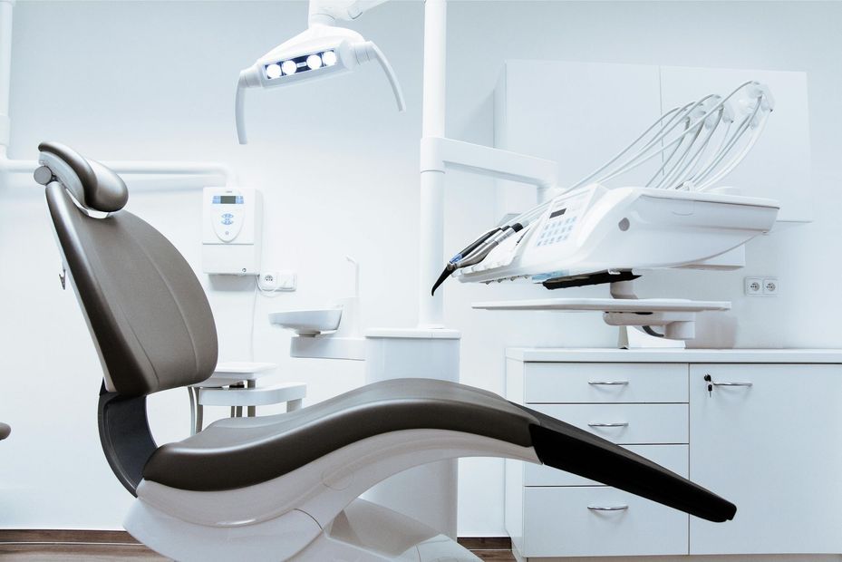 An empty dental chair in a dental office.