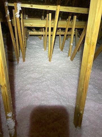 There is a lot of insulation in the attic of a house.