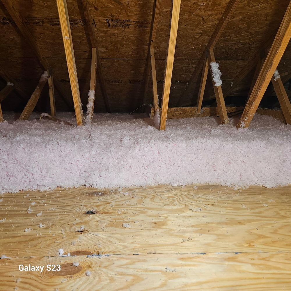 There is a lot of insulation in the attic of a house.