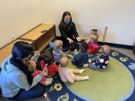 A group of infant and guide working together in a Montessori classroom