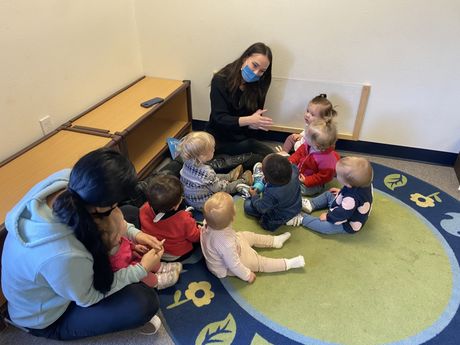 A group of infant and guide working together in a Montessori classroom