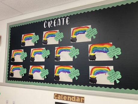 A bulletin board with rainbows and shamrocks on it