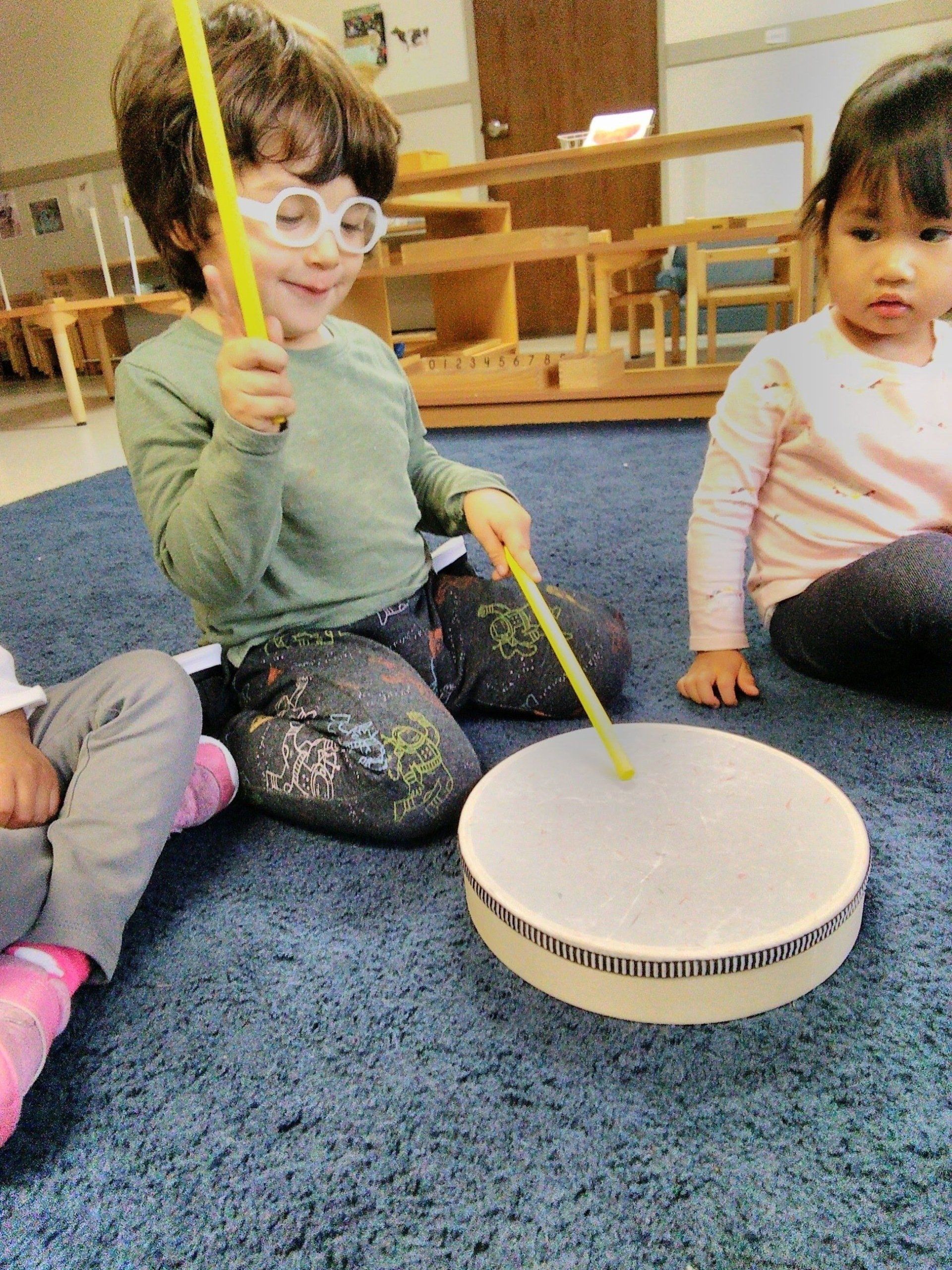 A group of child playing with instruments in a Montessori classroom