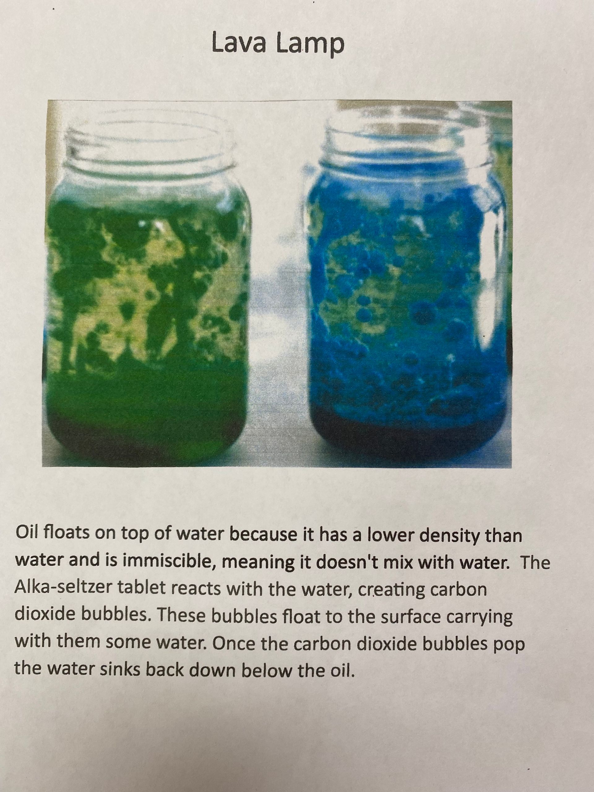 A picture of two jars filled with green and blue liquid simulating lava.