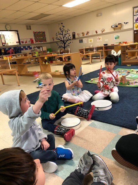 A group of child playing with instruments in a Montessori classroom