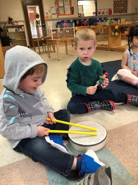 A group of child playing with instruments in a Montessori classroom