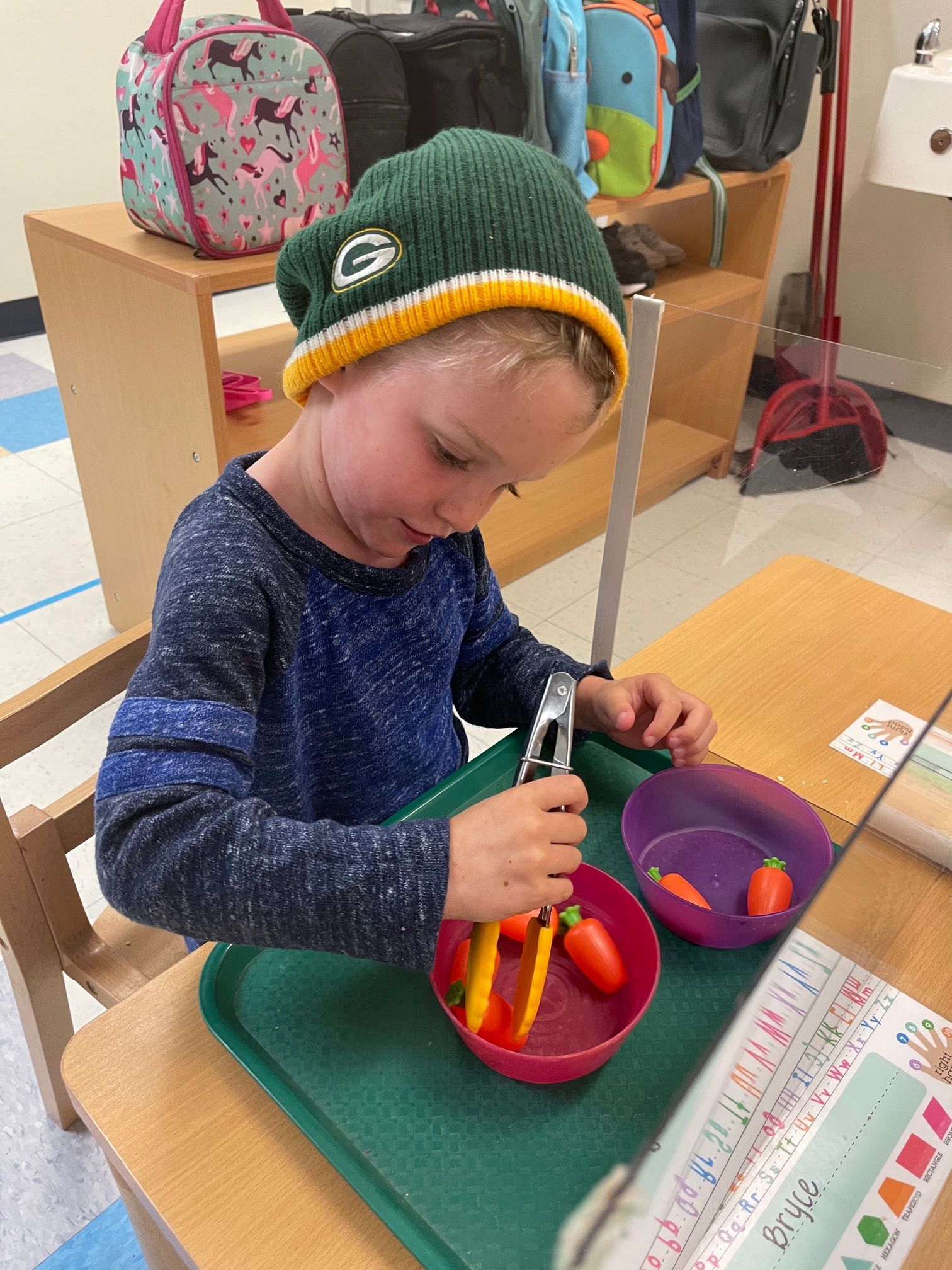 Child learning cooking experience in a Montessori classroom