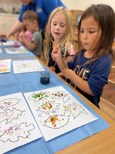 A Montessori child doing some art work in the classroom