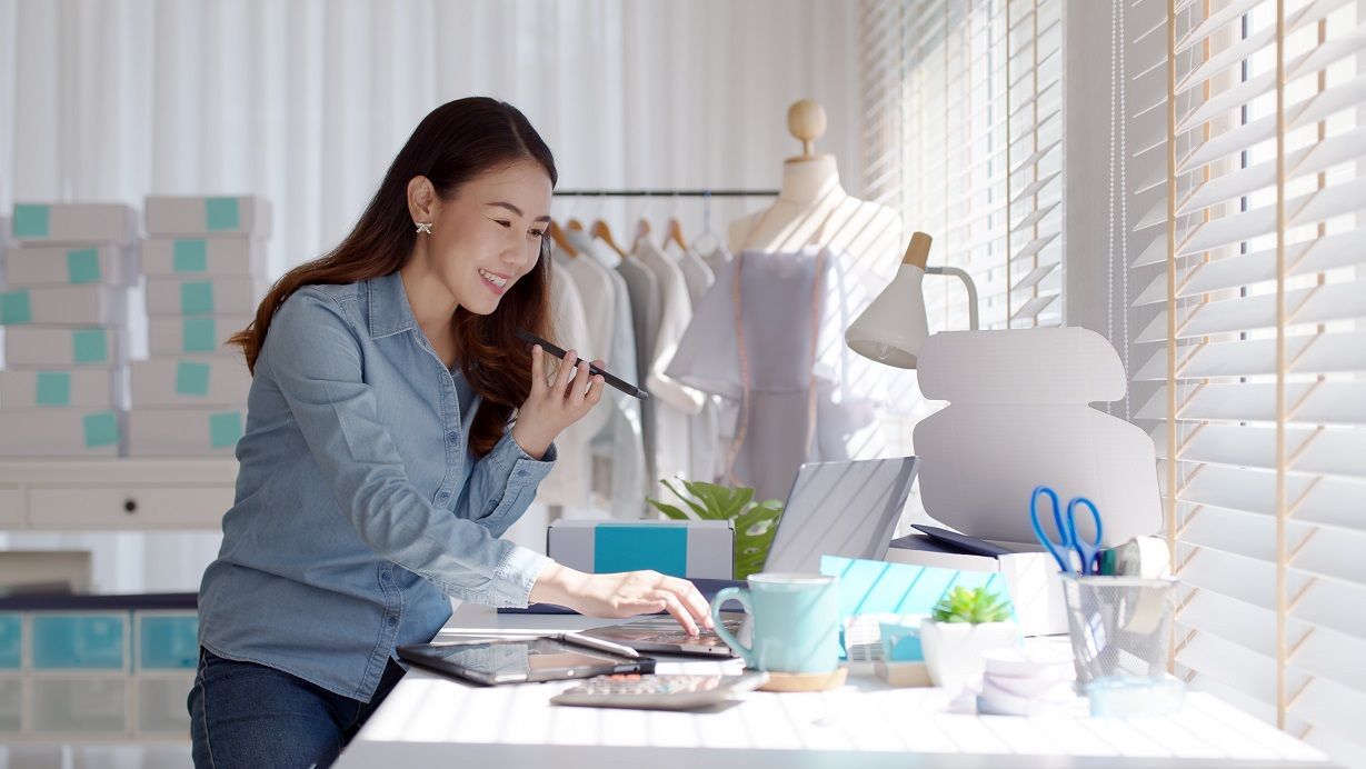 A woman using fashion ERP software to manage apparel industry business processes