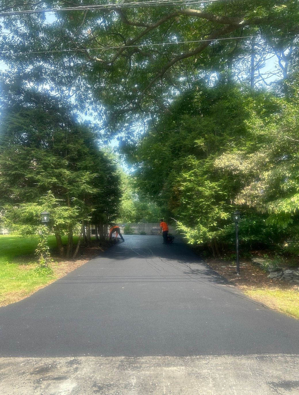 A man doing sealcoating in Cape Cod, MA - Cape Cod Paving hard at work