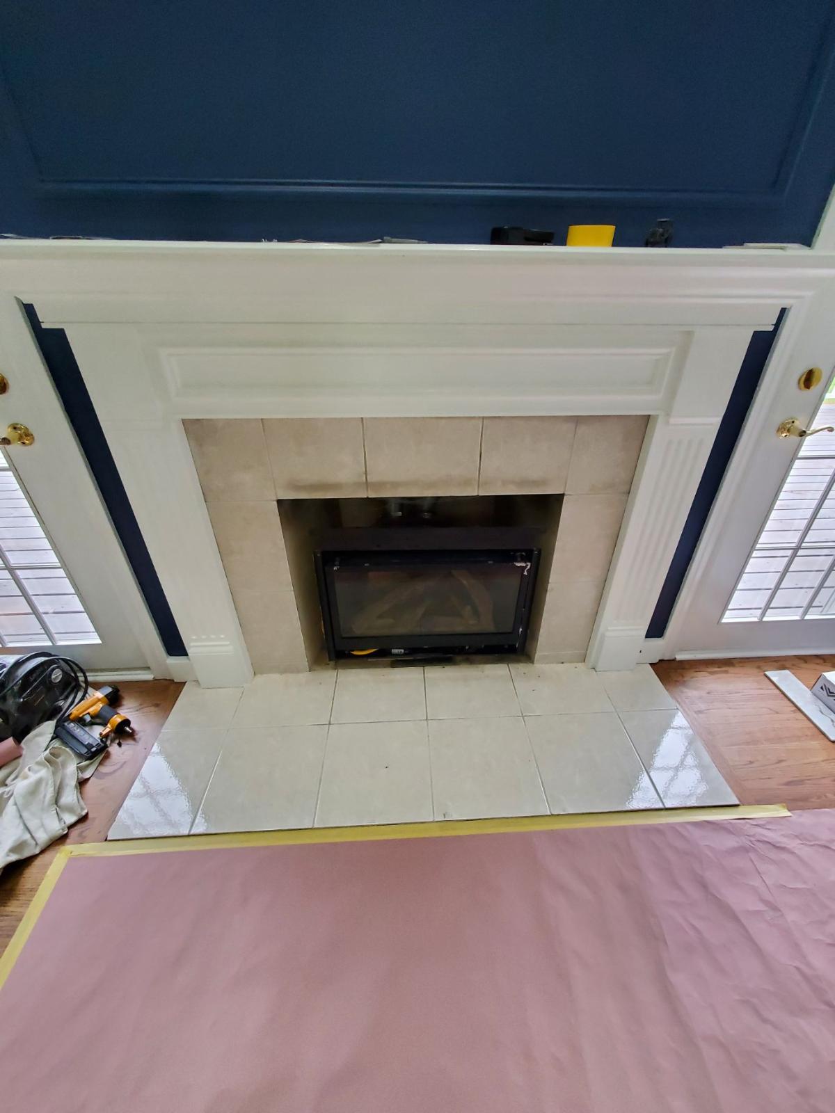 A fireplace with a flat screen tv sitting inside of it.