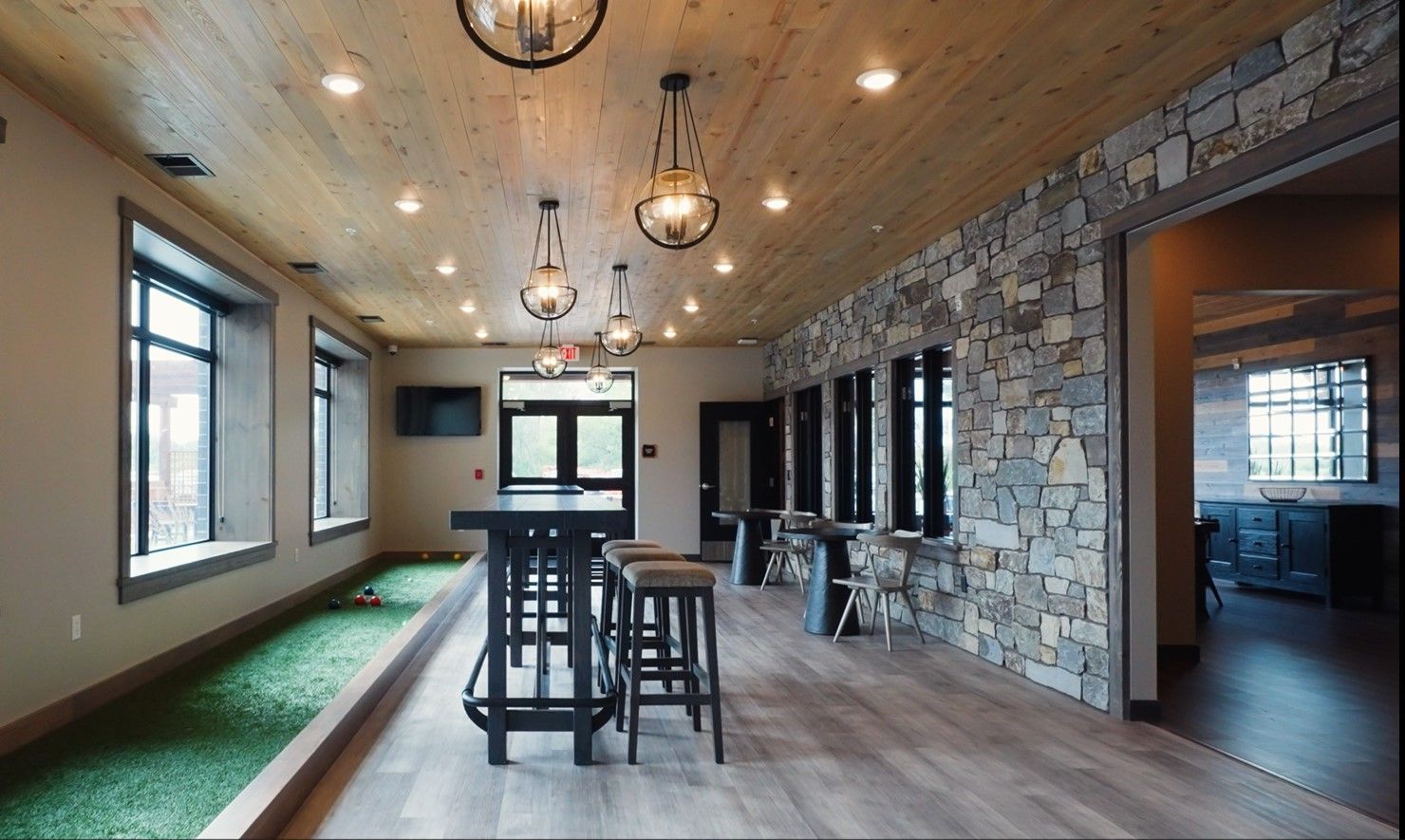 a large room with a table and stools in it