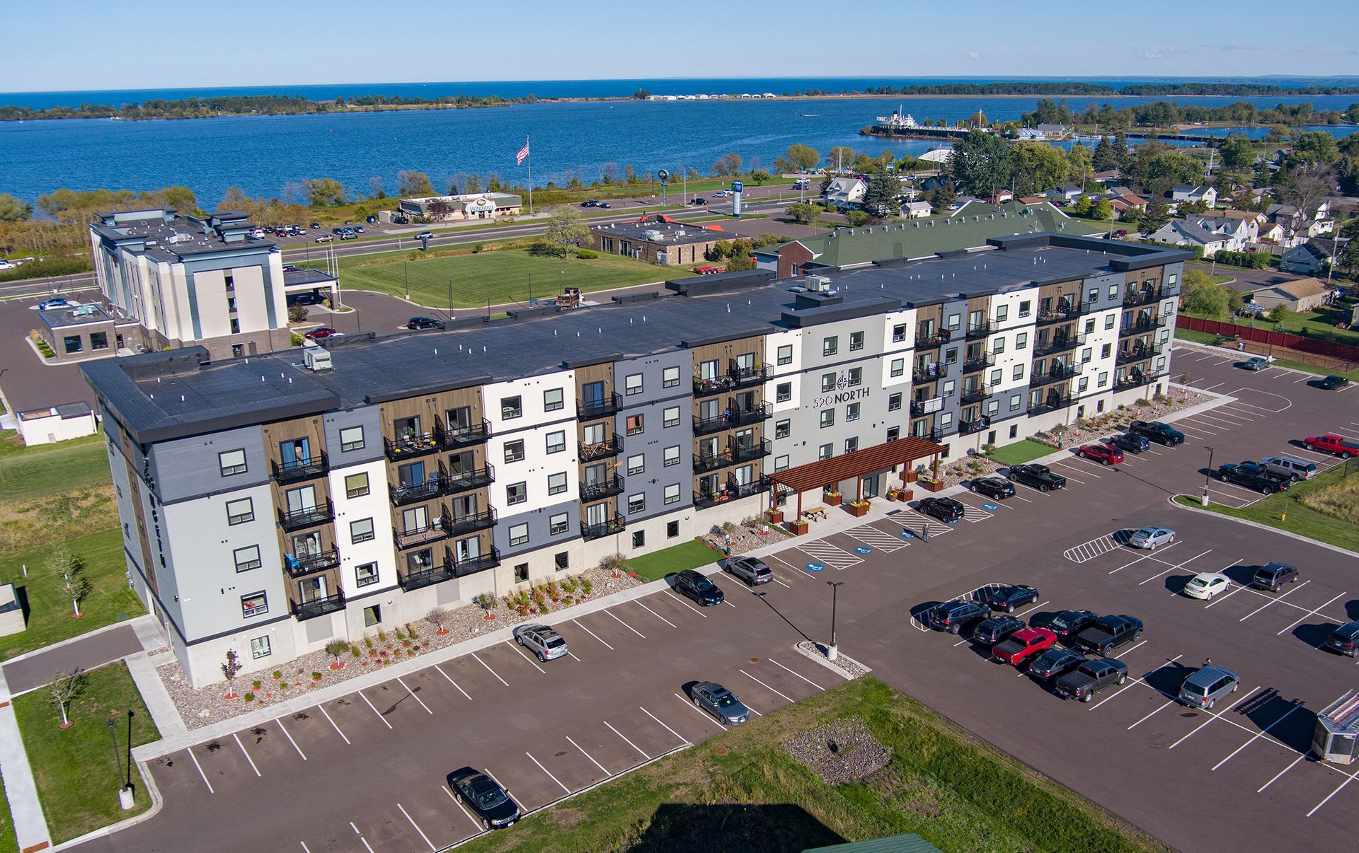 an aerial view of a large apartment building with a parking lot in front of it .
