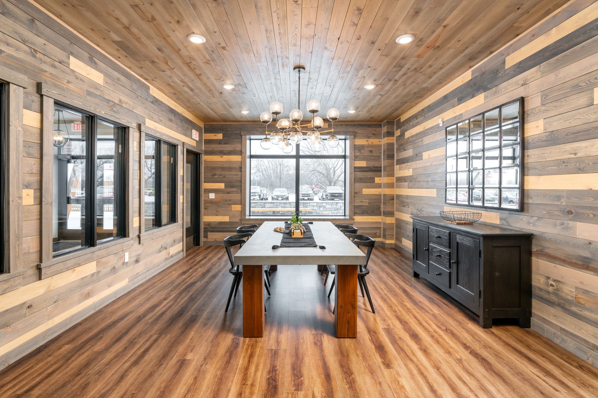 a large dining room with a wooden table and chairs .