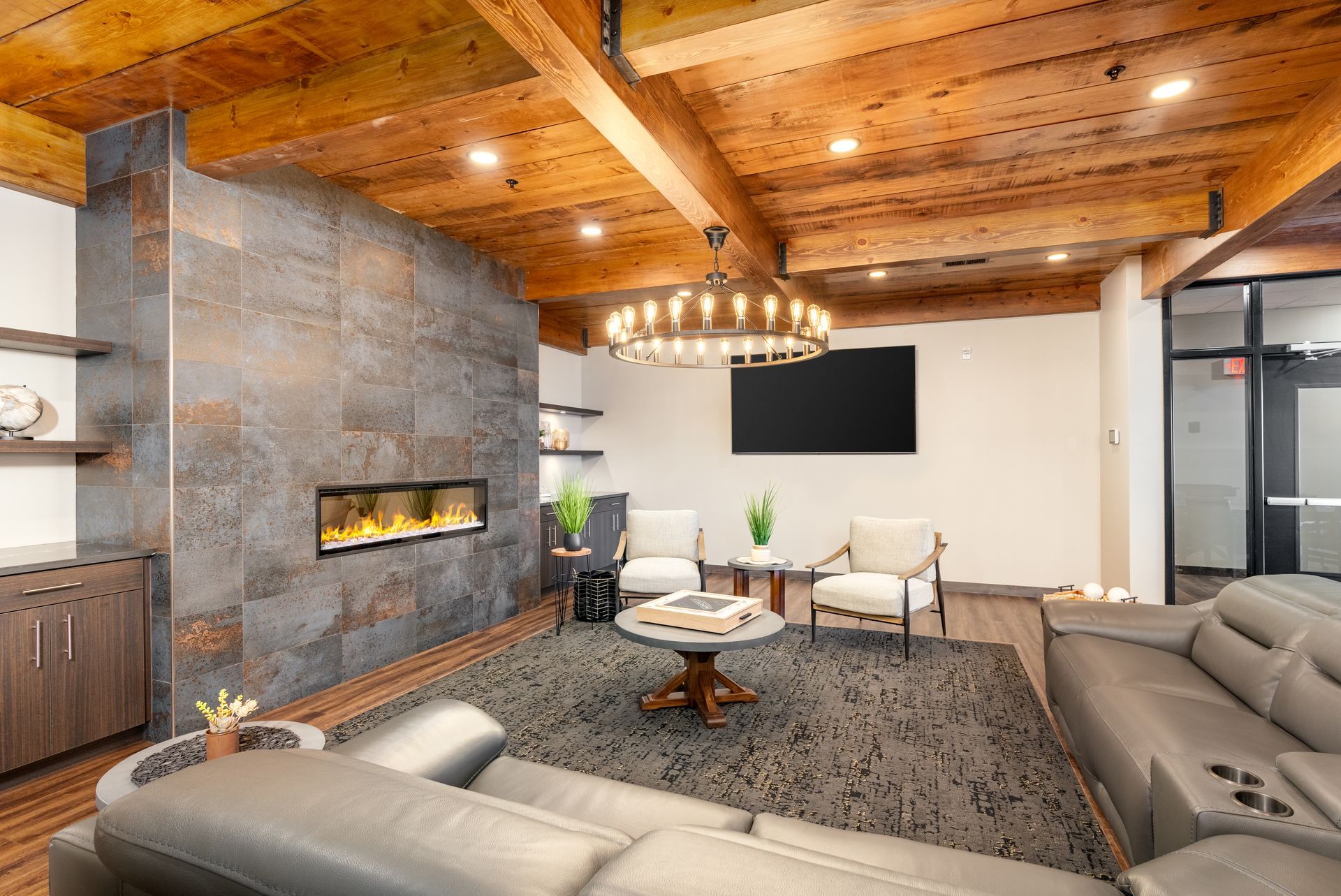 a living room with a couch , chairs , and a fireplace .