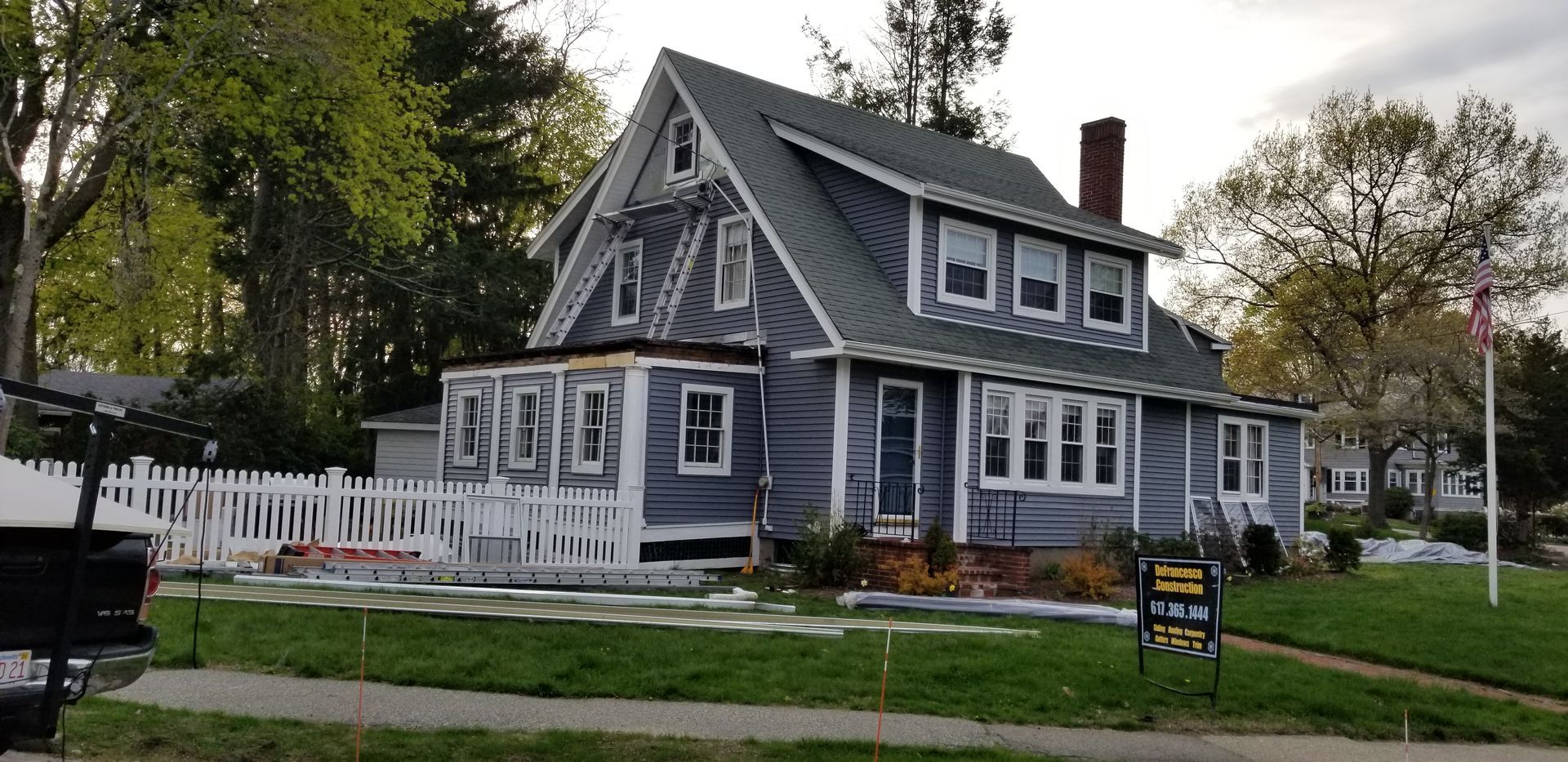 A large house with a white picket fence is for sale