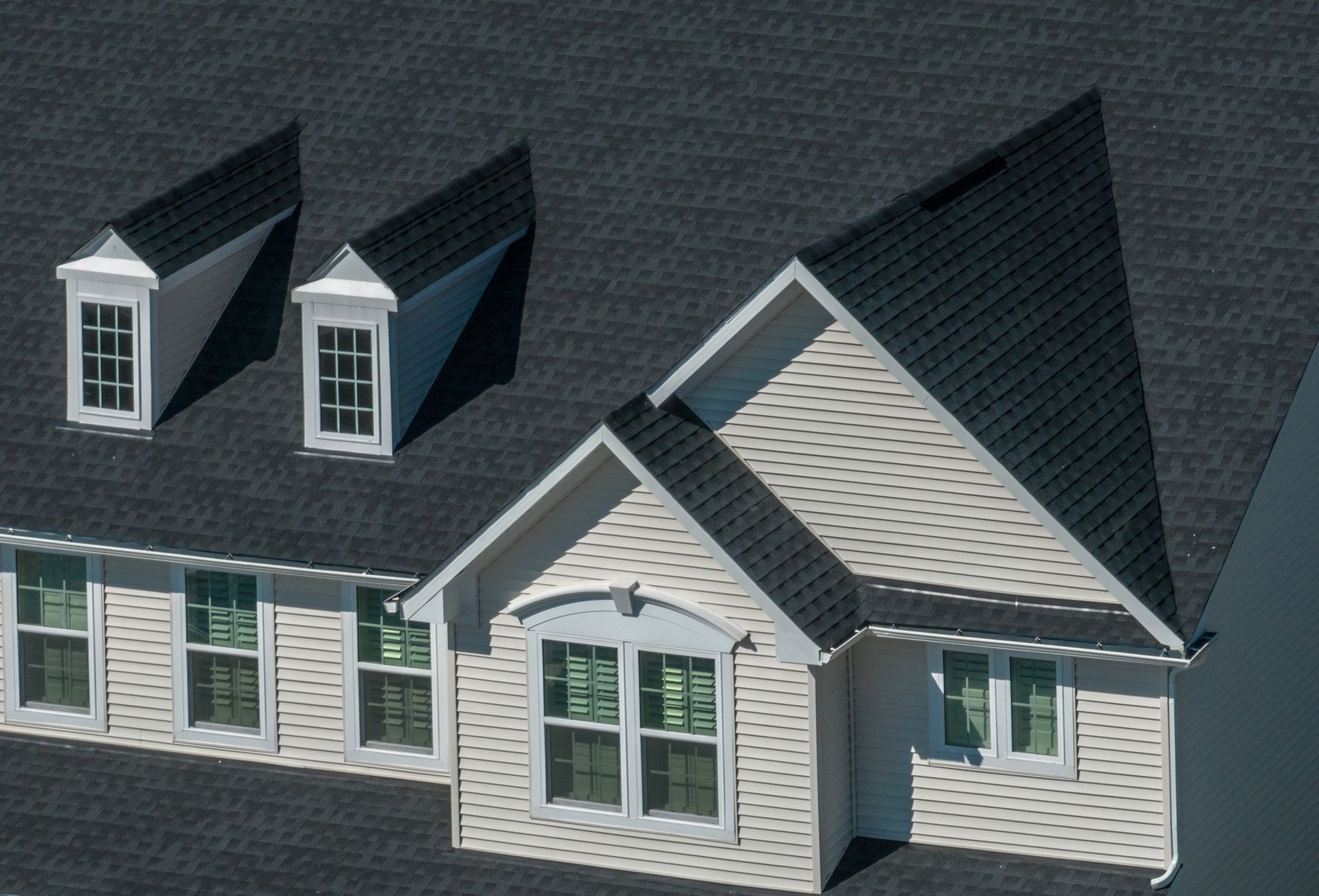 An aerial view of a house with a black roof