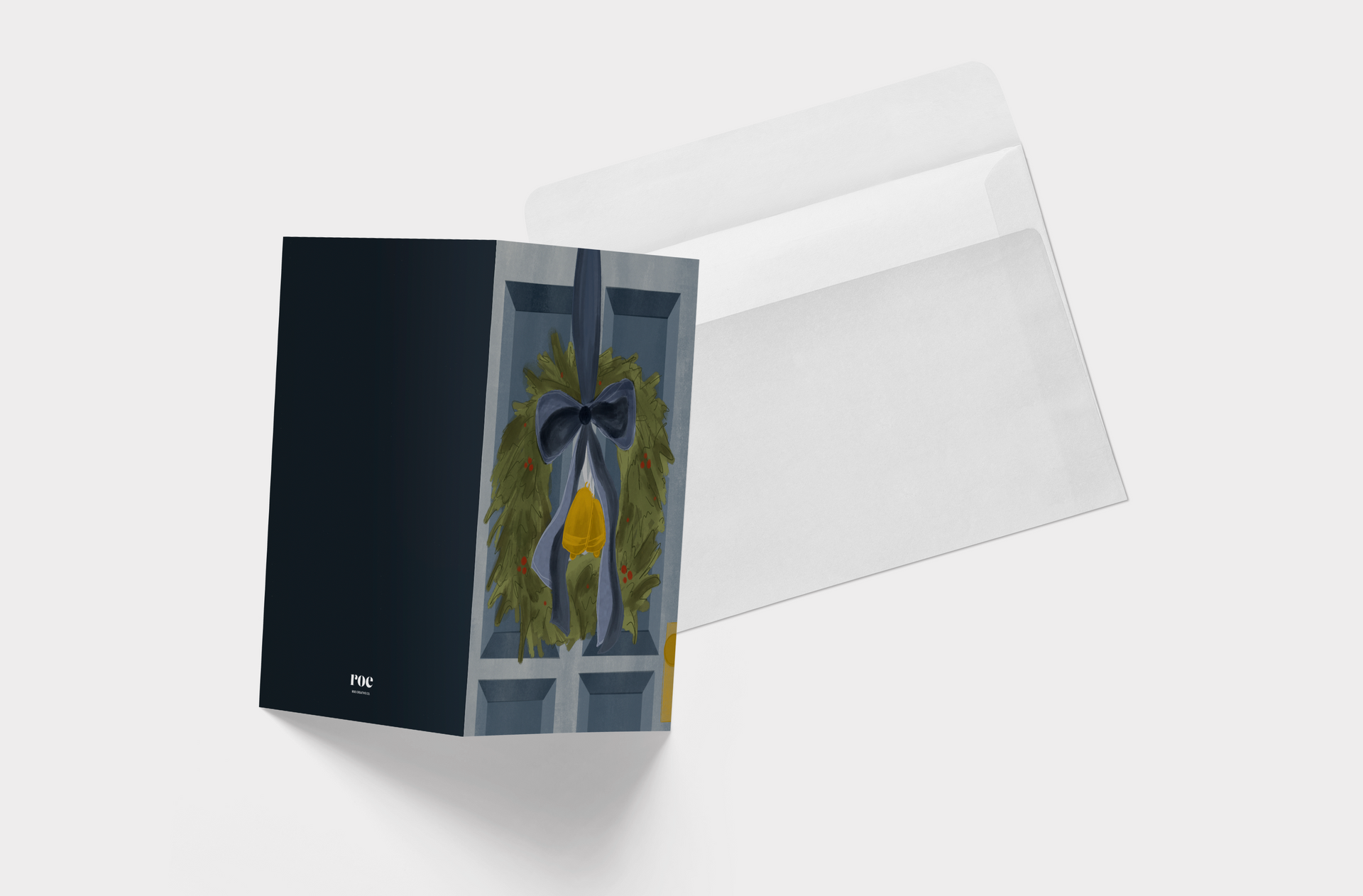 A christmas card with a wreath hanging on a door.